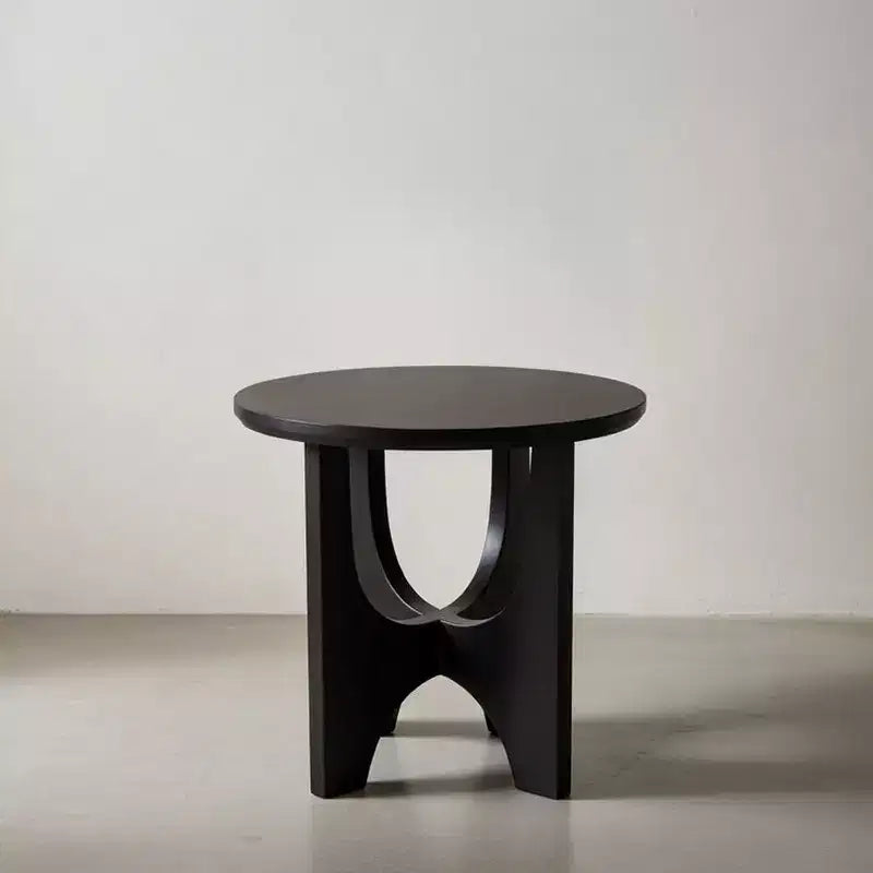 Round side table/coffee table featuring a 20-inch matte black solid mango wood tabletop and curved legs.
