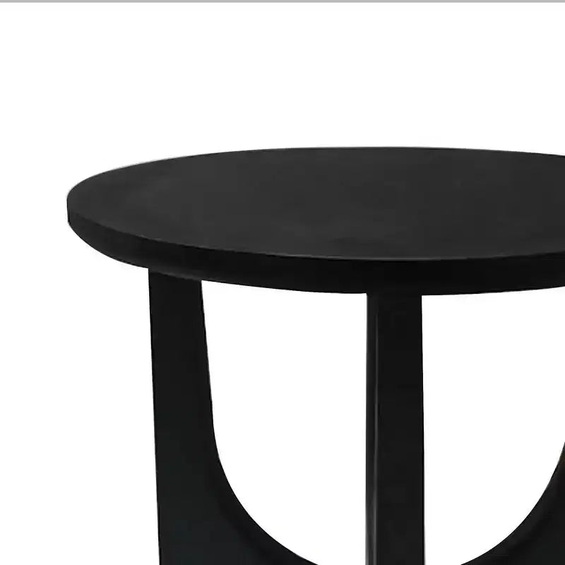Round side table/coffee table featuring a 20-inch matte black solid mango wood tabletop and curved legs.